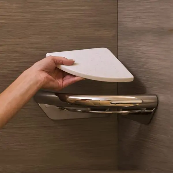 Woman showing how easy it is to remove and install the Invisia Corner Shelf